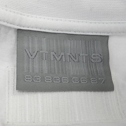 ブイティーエムエヌティーエス コットンTシャツ