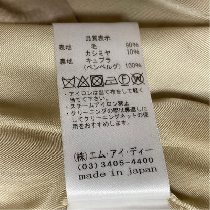 エムプルミエ COLOMBO生地ノーカラーベルテッドロングコート